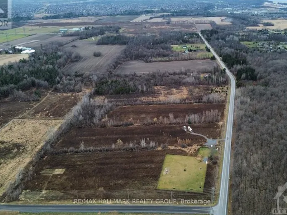 Exterior view of 1730 Wilhaven Drive, Ottawa — spacious country-style home with wide front lawn, mature trees, and a private driveway.