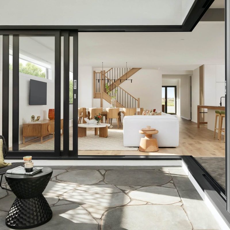 Stylish modern house exterior featuring geometric lines, minimalist design, and expansive glass elements.